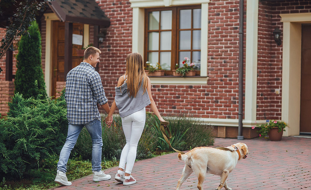 Blog Image Couple With Dog In Driveway