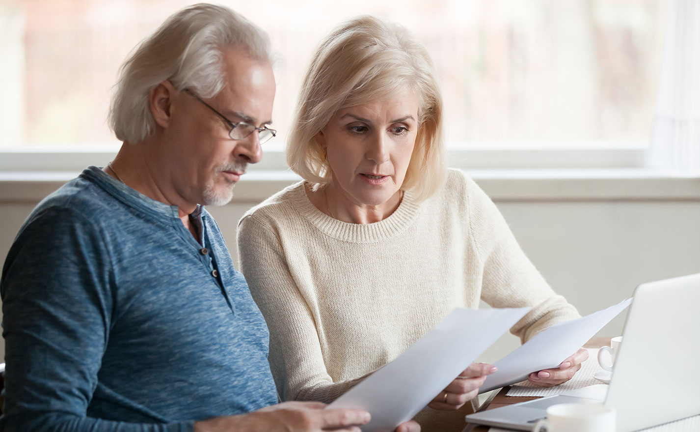 Holiday Scams Blog Feature Photo Of Senior Couple Reviewing Statements