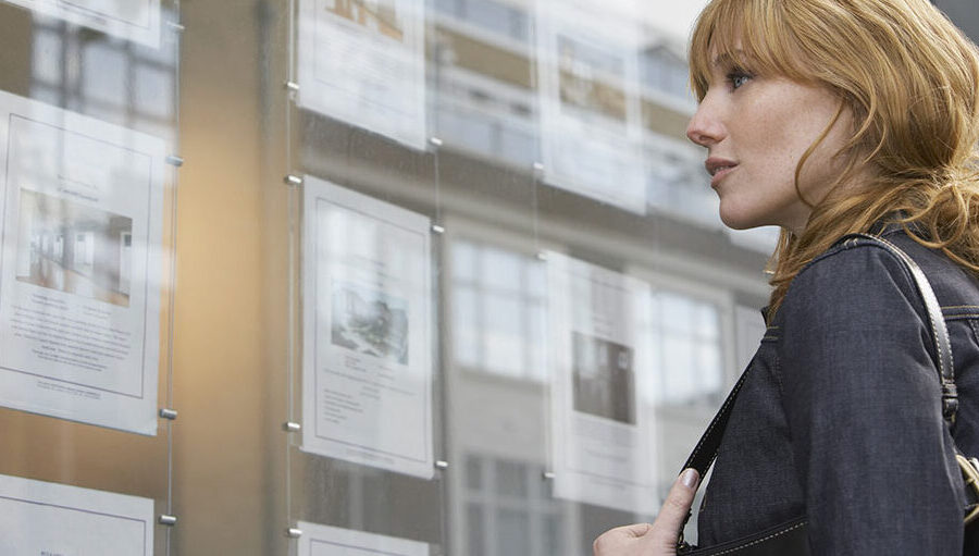 Woman viewing house listings preparing to buy a dream home