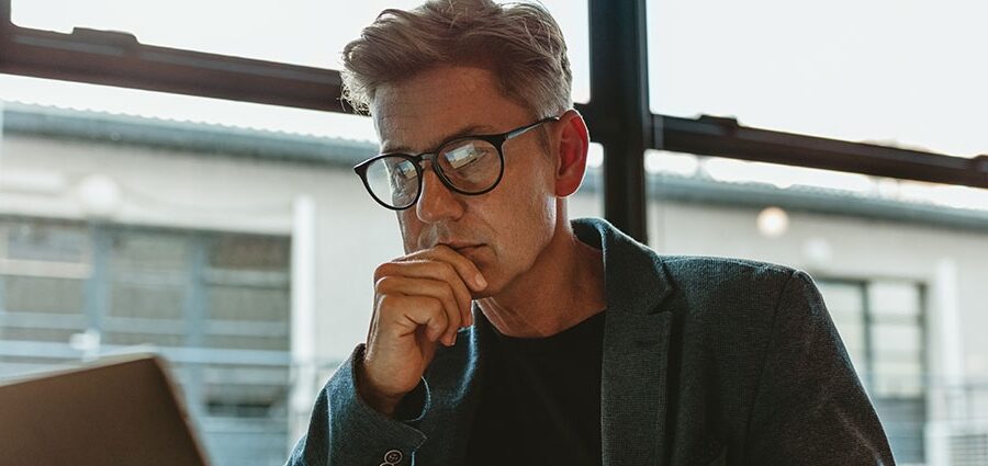 man looking into the 6 Types of Fraud in Business
