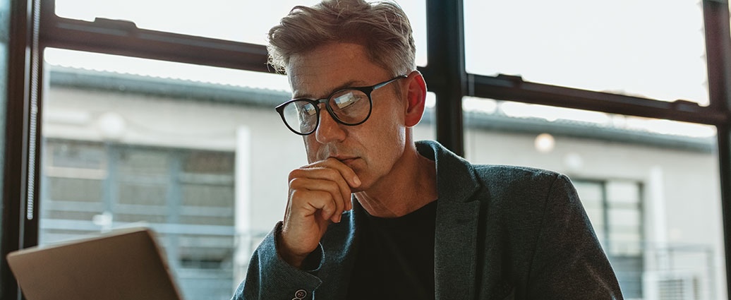 man looking into the 6 Types of Fraud in Business