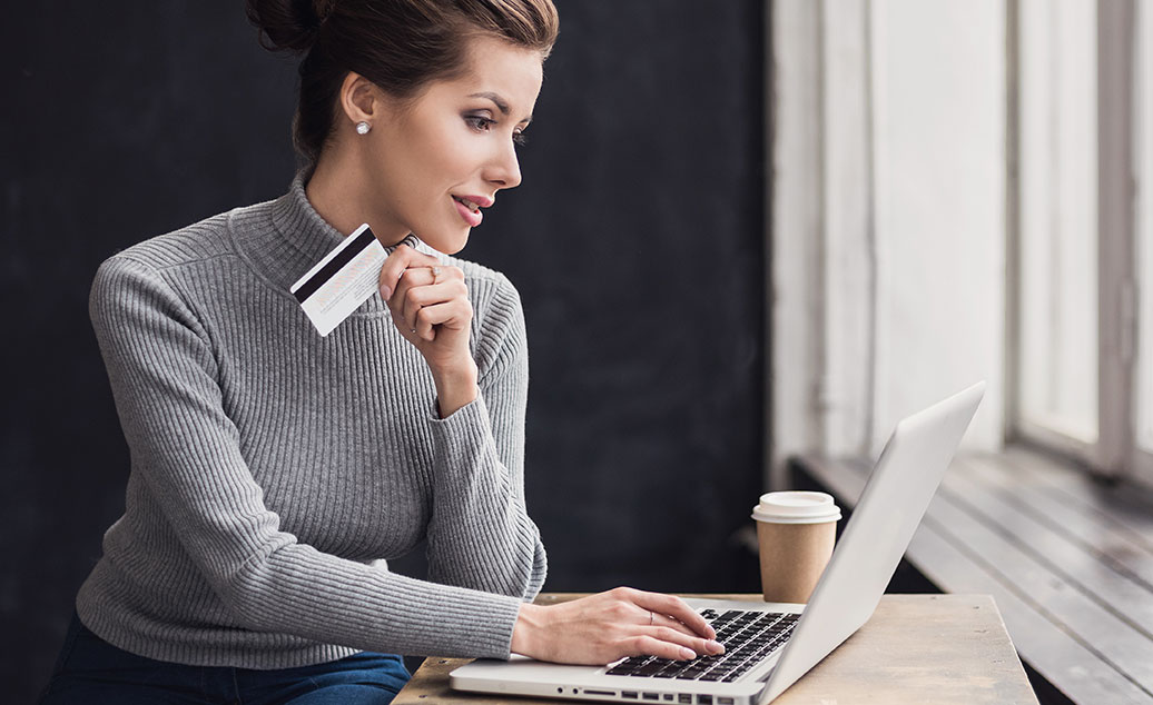 Woman with credit card shopping online