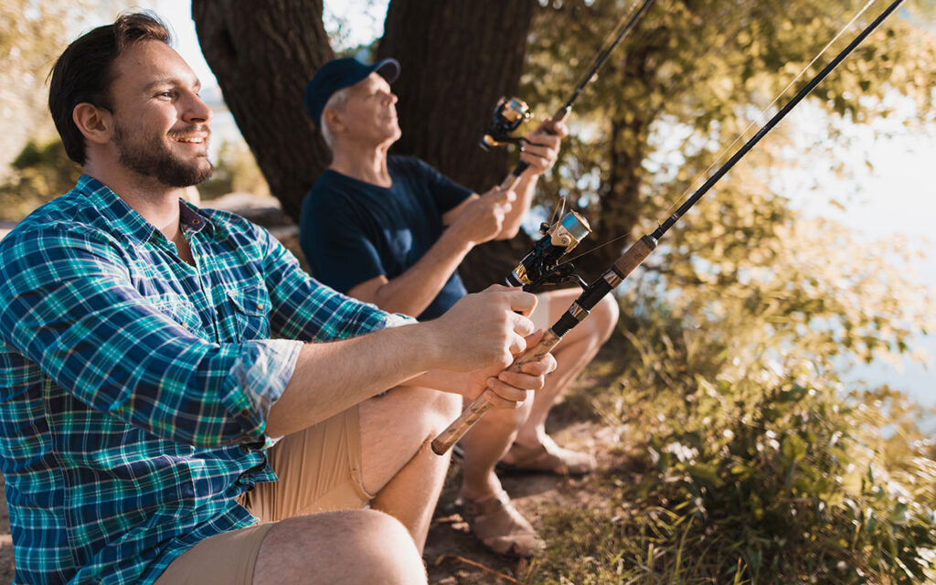 Father and son fishing illustrating financial goals and savings.