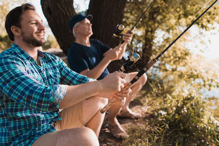 Father and son fishing illustrating financial goals and savings.