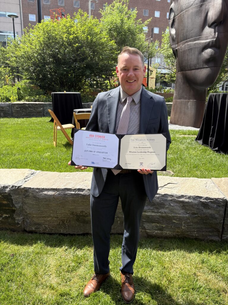 Luke Donnenwerth, Bank Midwest President, holding ABA Stonier Graduate School of Banking diploma.