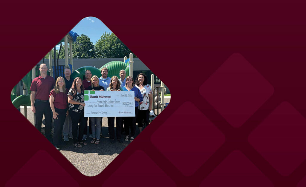 Bank Midwest employees present $25,000 check to reps for Windom Area Daycare