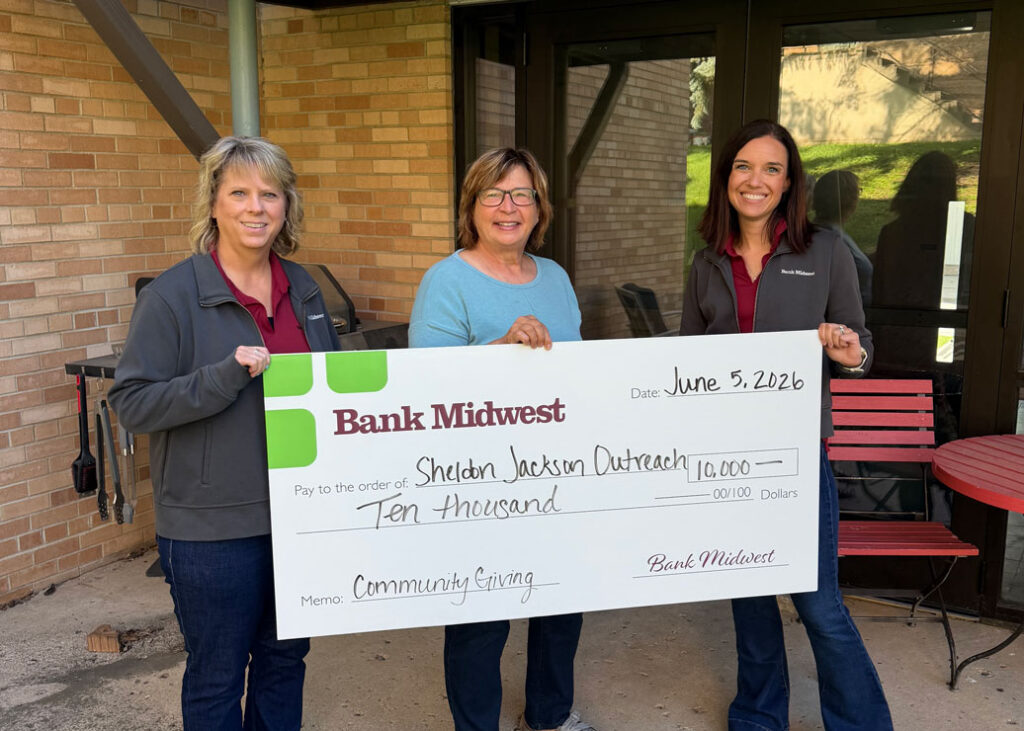 Bank Midwest representatives presenting a $10,000 check to Sheldon Jackson Outreach Center staff.