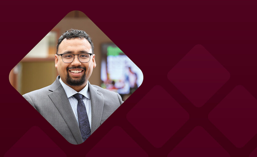 Allan Hernandex headshot with burgundy background